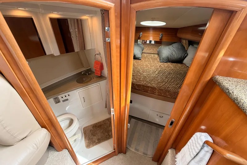 Slide: The Image of 2005 Carver 41 Cockpit Motor Yacht interior with bathroom and cozy bedroom. - 21