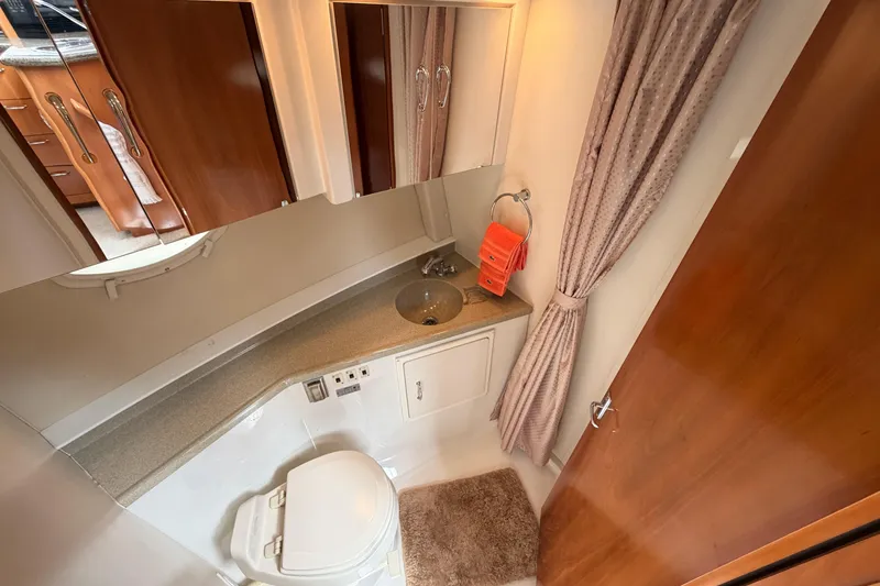 Slide: The Image of Bathroom interior of 2005 Carver 41 Cockpit Motor Yacht with sink, toilet, and mirror. - 22