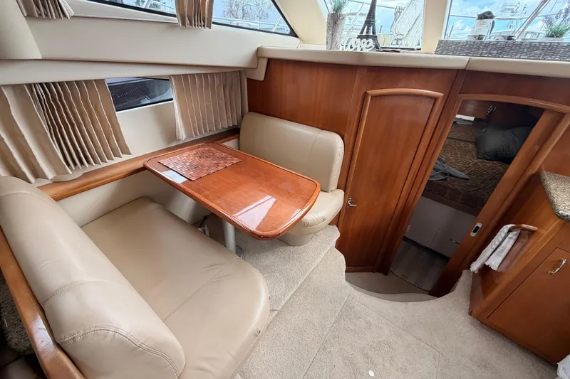 Slide: The Image of Interior of 2005 Carver 41 Cockpit Motor Yacht with dining area and cabin entrance. - 25