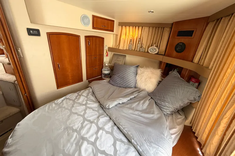 Slide: The Image of Luxurious bedroom interior of 2005 Carver 41 Cockpit Motor Yacht with plush bedding. - 29