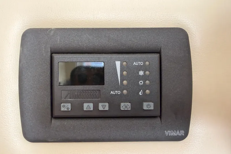 Slide: The Image of Control panel on a 2005 Carver 41 Cockpit Motor Yacht, featuring Vimar interface. - 34