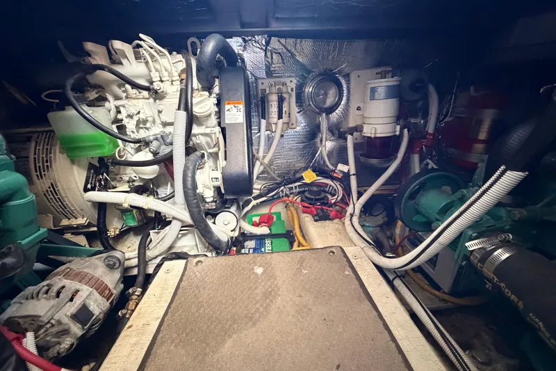 Slide: The Image of Engine room of a 2005 Carver 41 Cockpit Motor Yacht, showcasing mechanical components. - 37