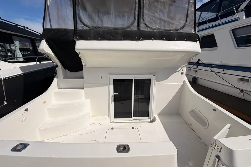 Slide: The Image of 2005 Carver 41 Cockpit Motor Yacht with spacious deck and sliding glass doors. - 4