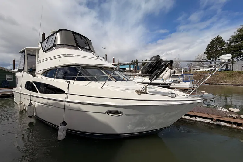 Slide: The Image of 2005 Carver 41 Cockpit Motor Yacht docked at marina under cloudy sky. - 6