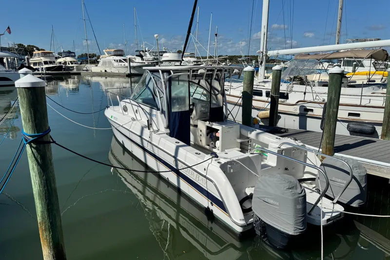 The Image of 2011 Glacier Bay 2670 Cuddy boat docked in a marina with other vessels. - 1