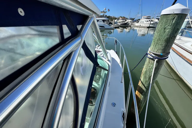 Slide: The Image of 2011 Glacier Bay 2670 Cuddy boat docked at marina, clear blue sky. - 12