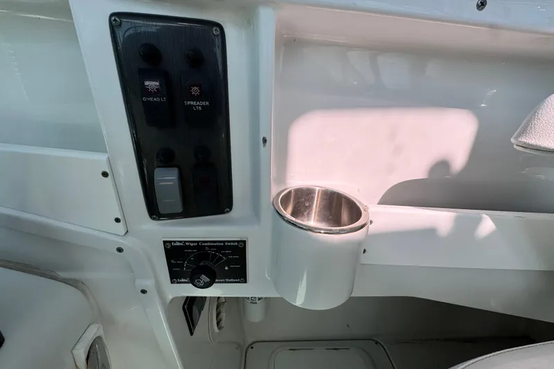 Slide: The Image of Control panel and cup holder on 2011 Glacier Bay 2670 Cuddy boat interior. - 13