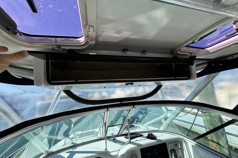 Slide: The Image of Interior view of a 2011 Glacier Bay 2670 Cuddy boat cockpit with open hatch. - 14