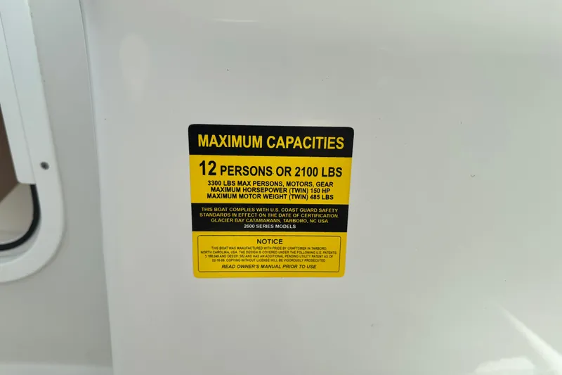 Slide: The Image of Maximum capacity label on 2011 Glacier Bay 2670 Cuddy boat, indicating 12 persons or 2100 lbs. - 17