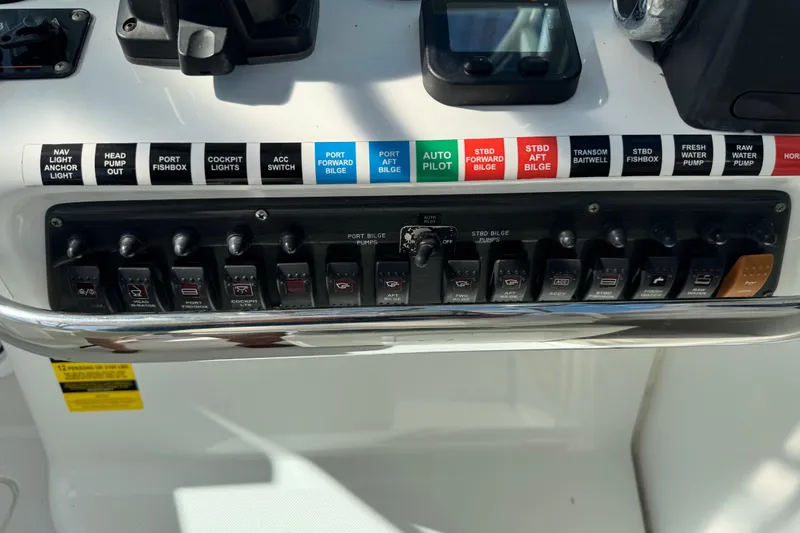 Slide: The Image of Control panel of a 2011 Glacier Bay 2670 Cuddy boat with labeled switches. - 18