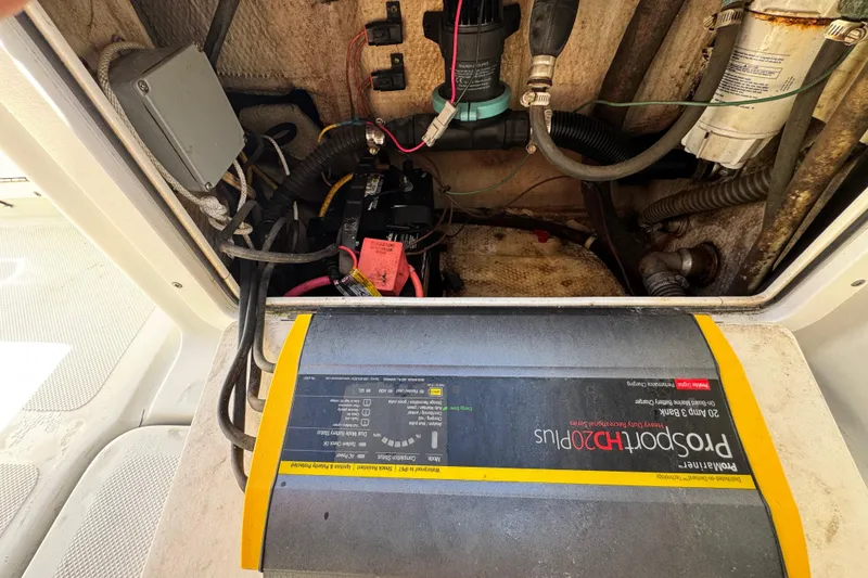 Slide: The Image of Electrical components inside a 2011 Glacier Bay 2670 Cuddy boat, featuring a ProSport HD20 Plus charger. - 19