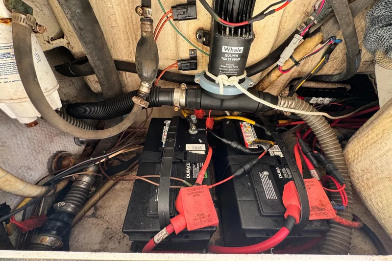 Slide: The Image of Engine compartment of 2011 Glacier Bay 2670 Cuddy with batteries and wiring. - 20