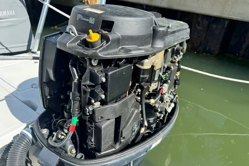 Slide: The Image of Open engine of a 2011 Glacier Bay 2670 Cuddy boat, docked by the water. - 21