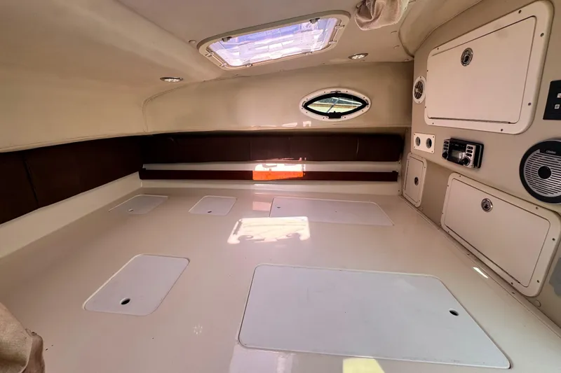 Slide: The Image of Interior cabin of 2011 Glacier Bay 2670 Cuddy boat, featuring storage and porthole. - 25