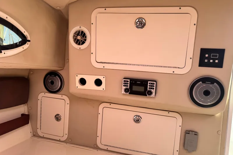 Slide: The Image of Interior of 2011 Glacier Bay 2670 Cuddy boat with audio system and storage compartments. - 26