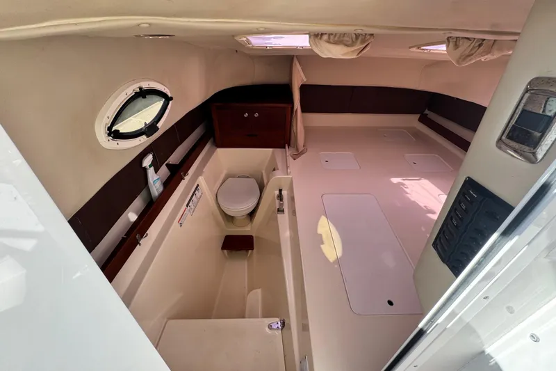 Slide: The Image of 2011 Glacier Bay 2670 Cuddy cabin interior with toilet and storage compartments. - 28