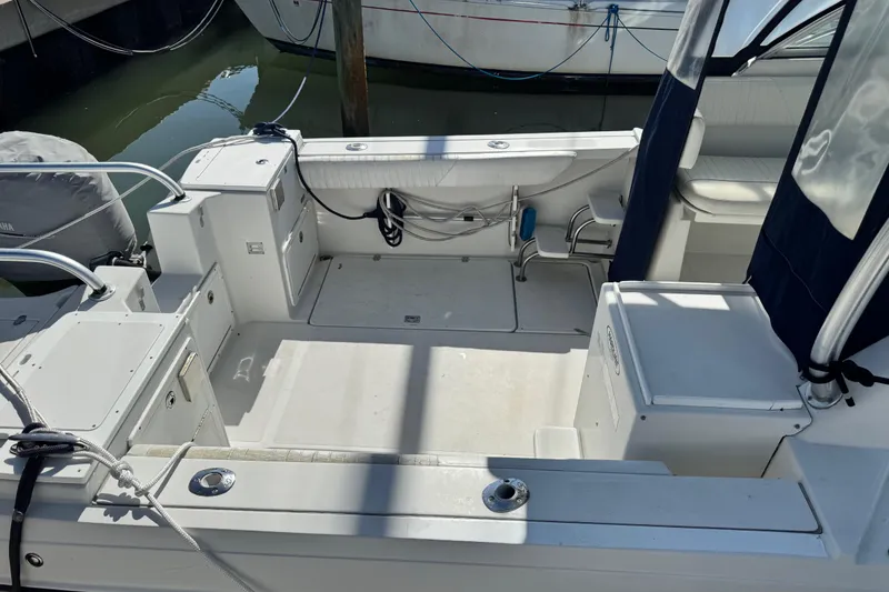 Slide: The Image of 2011 Glacier Bay 2670 Cuddy boat interior with seating and storage compartments. - 3