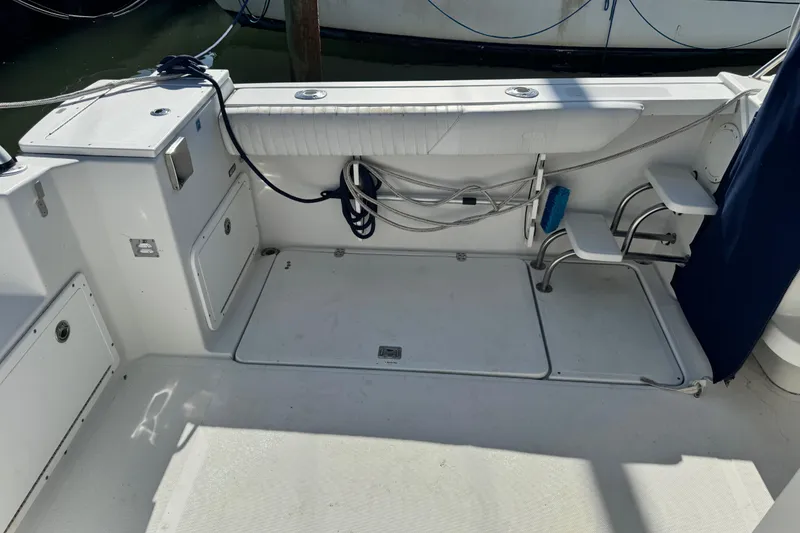 Slide: The Image of 2011 Glacier Bay 2670 Cuddy boat interior with seating and storage compartments. - 38