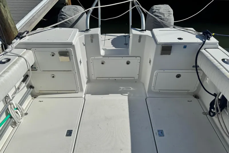Slide: The Image of 2011 Glacier Bay 2670 Cuddy boat interior with storage compartments and seating. - 40