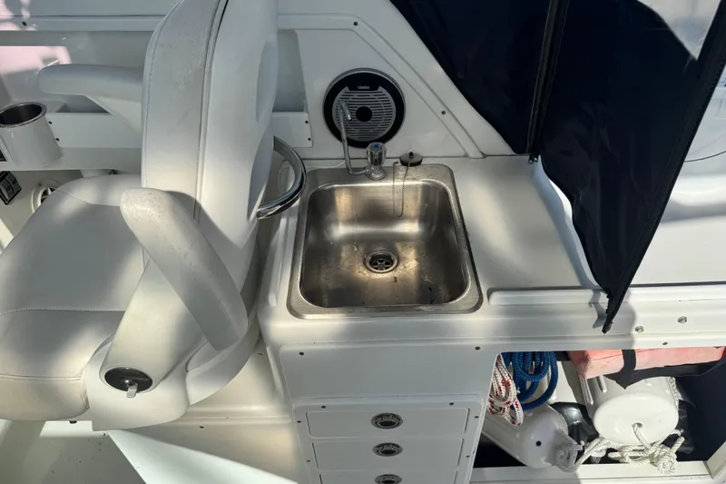 Slide: The Image of Interior of 2011 Glacier Bay 2670 Cuddy featuring a sink and seating area. - 41