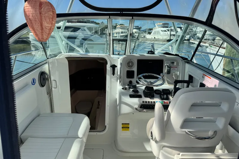 Slide: The Image of Interior view of 2011 Glacier Bay 2670 Cuddy boat cockpit with steering wheel and controls. - 43