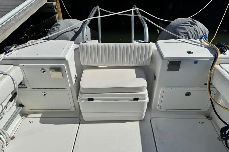 Slide: The Image of 2011 Glacier Bay 2670 Cuddy boat interior with seating and storage compartments. - 46