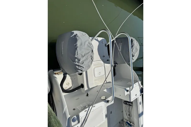 Slide: The Image of 2011 Glacier Bay 2670 Cuddy boat with Yamaha engine covers, docked on calm water. - 5