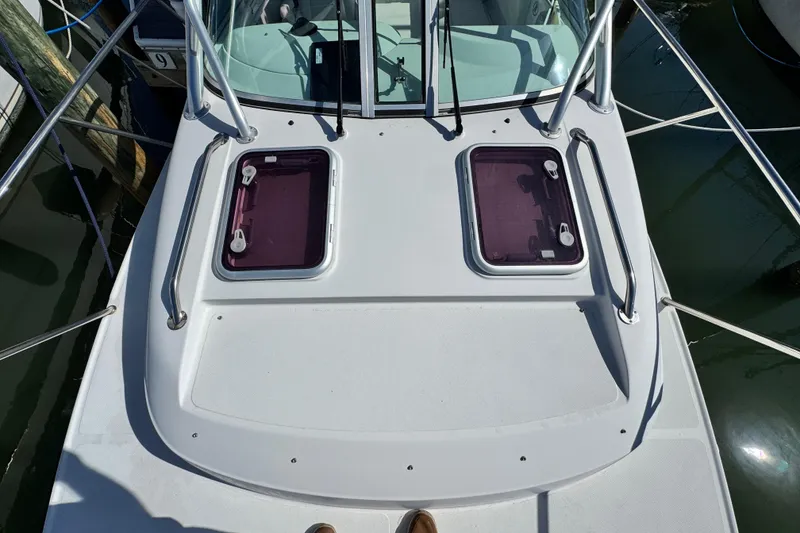 Slide: The Image of 2011 Glacier Bay 2670 Cuddy boat deck with dual hatches and railing. - 7