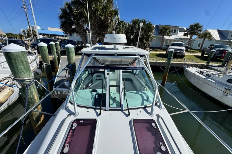 Slide: The Image of 2011 Glacier Bay 2670 Cuddy boat docked at marina with clear blue sky. - 8