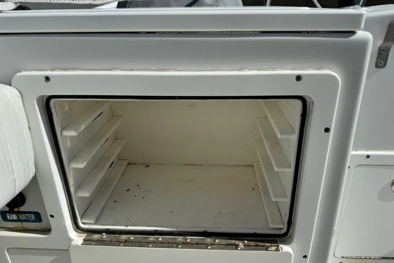 Slide: The Image of Open storage compartment on a 2011 Glacier Bay 2670 Cuddy boat. - 9