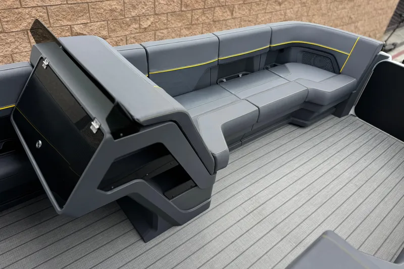 Slide: The Image of 2025 Manitou EXPLORE 24 boat interior with sleek gray seating and modern design. - 11