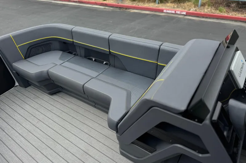 Slide: The Image of Luxurious seating on 2025 Manitou EXPLORE 24 boat with sleek gray upholstery and yellow accents. - 12