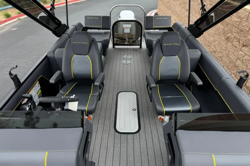 Slide: The Image of 2025 Manitou EXPLORE 24 boat interior with sleek seating and modern design. - 13