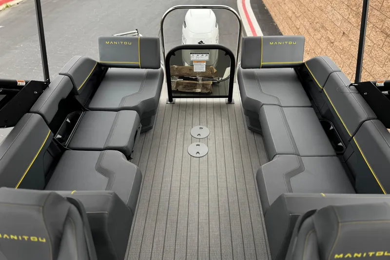 Slide: The Image of 2025 Manitou EXPLORE 24 boat interior with sleek seating and modern design. - 14
