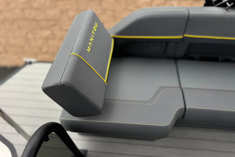 Slide: The Image of 2025 Manitou EXPLORE 24 boat seat with gray upholstery and yellow stitching. - 16