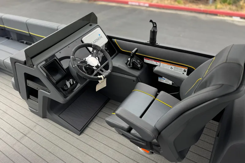 Slide: The Image of Interior of 2025 Manitou EXPLORE 24 boat with modern steering and seating. - 22