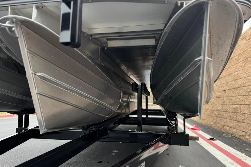 Slide: The Image of Underneath view of a 2025 Manitou EXPLORE 24 pontoon boat on a trailer. - 4