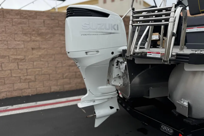 Slide: The Image of 2025 Manitou EXPLORE 24 with Suzuki outboard motor and stainless steel ladder. - 7