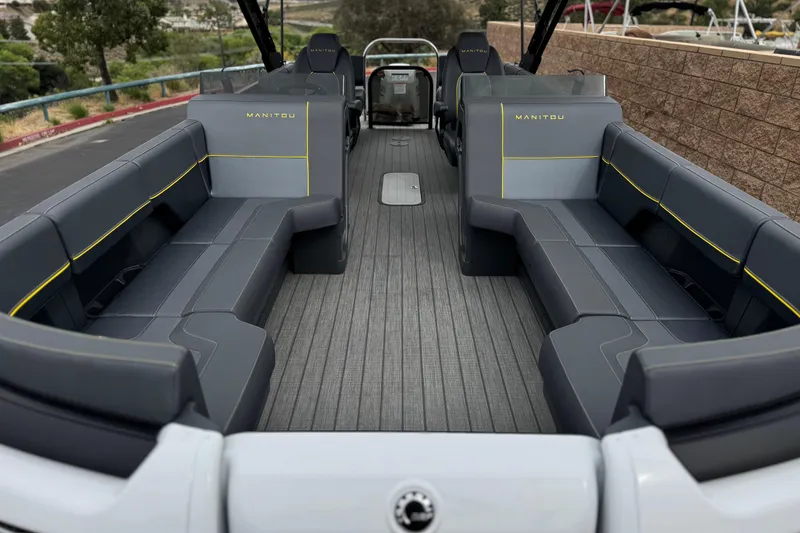 Slide: The Image of 2025 Manitou EXPLORE 24 boat interior with spacious seating and modern design. - 9