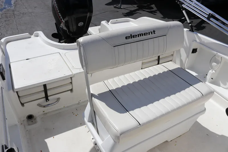 Slide: The Image of 2020 Bayliner Element boat interior with white seating and storage compartments. - 10