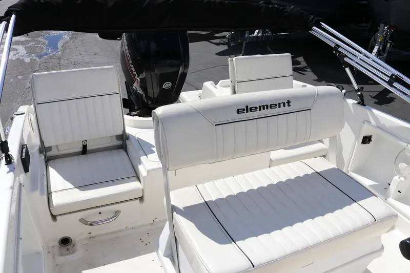Slide: The Image of 2020 Bayliner Element boat interior with white seating and Mercury outboard motor. - 12
