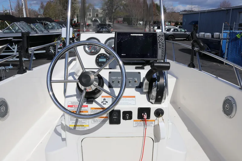 Slide: The Image of 2020 Bayliner Element boat dashboard with steering wheel and navigation controls. - 14