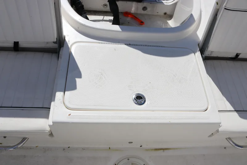 Slide: The Image of 2020 Bayliner Element boat deck with storage compartment and seating area. - 15