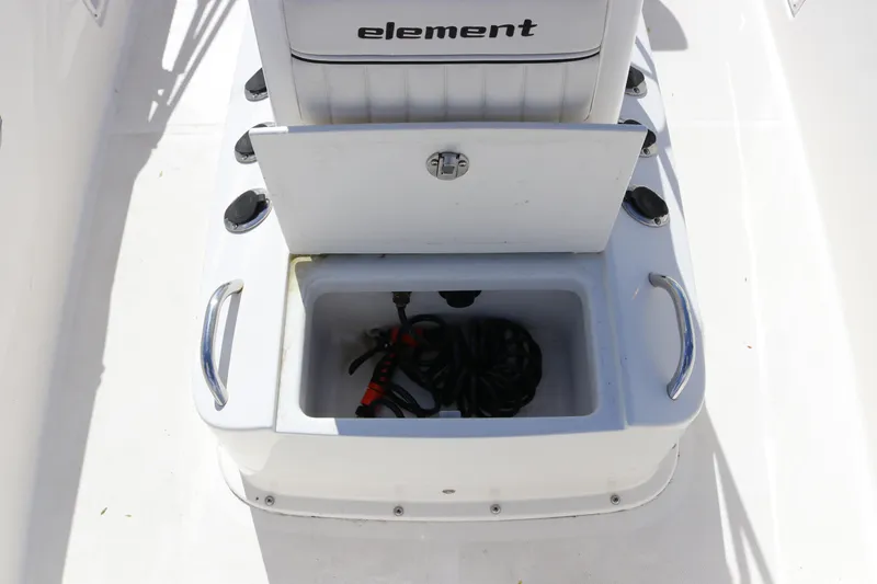 Slide: The Image of 2020 Bayliner Element boat storage compartment with open lid and coiled rope inside. - 22