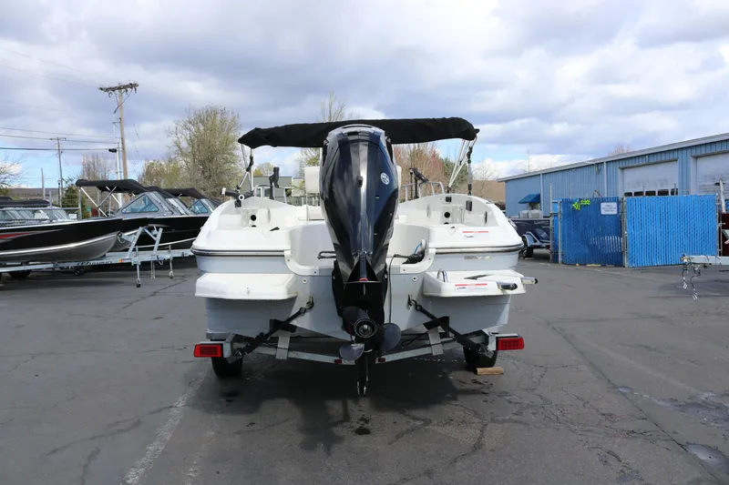 Slide: The Image of 2020 Bayliner Element boat with outboard motor in a marina parking lot. - 3