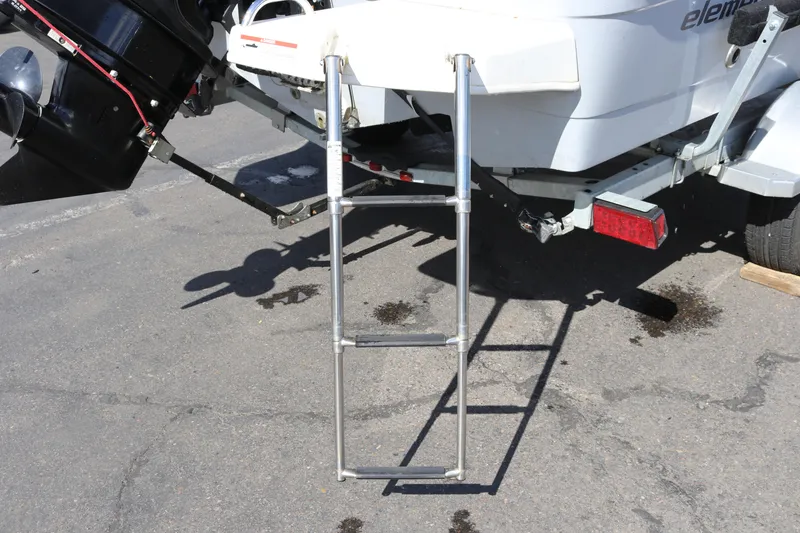 Slide: The Image of 2020 Bayliner Element boat with extended swim ladder and visible outboard motor. - 31