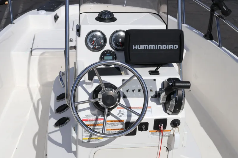 Slide: The Image of 2020 Bayliner Element boat dashboard with steering wheel and Humminbird navigation system. - 8