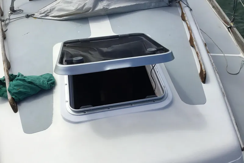 Slide: The Image of 1977 Gulfstar 37 sailboat with solar panels on deck, docked in a marina. - 6