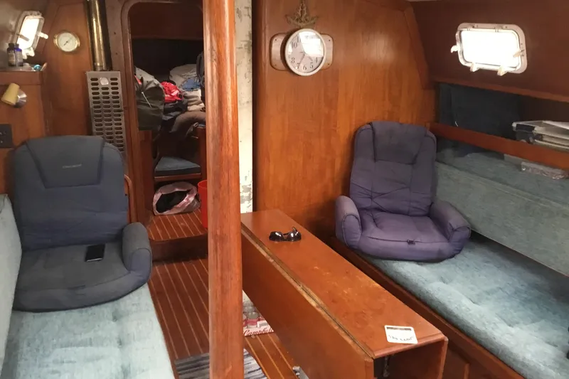 Slide: The Image of Interior of a 1977 Gulfstar 37 sailboat with cozy seating and wooden finishes. - 9