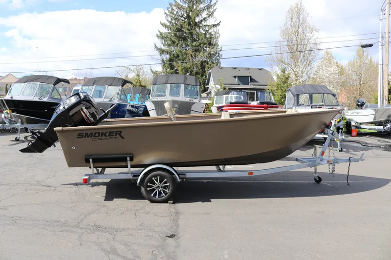 The Image of 2026 Smoker Craft Freedom 160 TL boat on trailer, parked outdoors. - 1